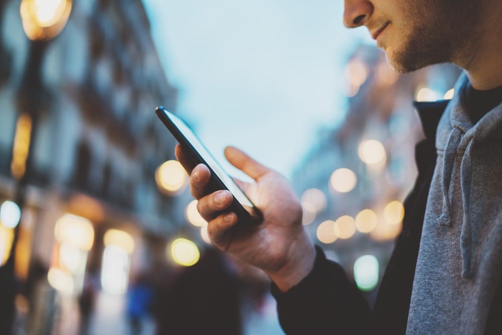 A guy checking navigation app on his phone.