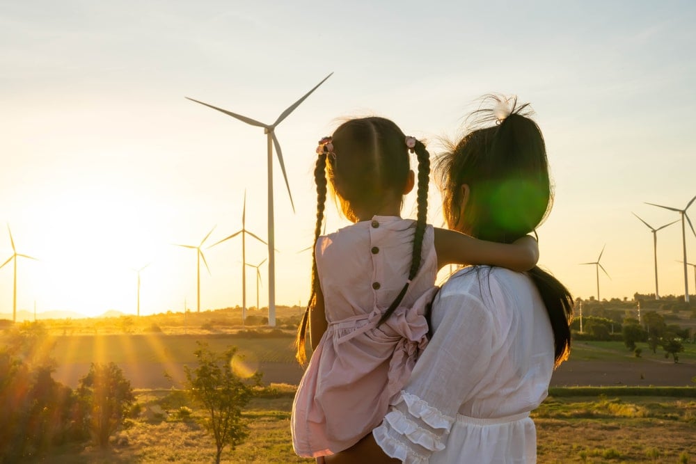 A mother and her daughter are watching beautiful sunset.