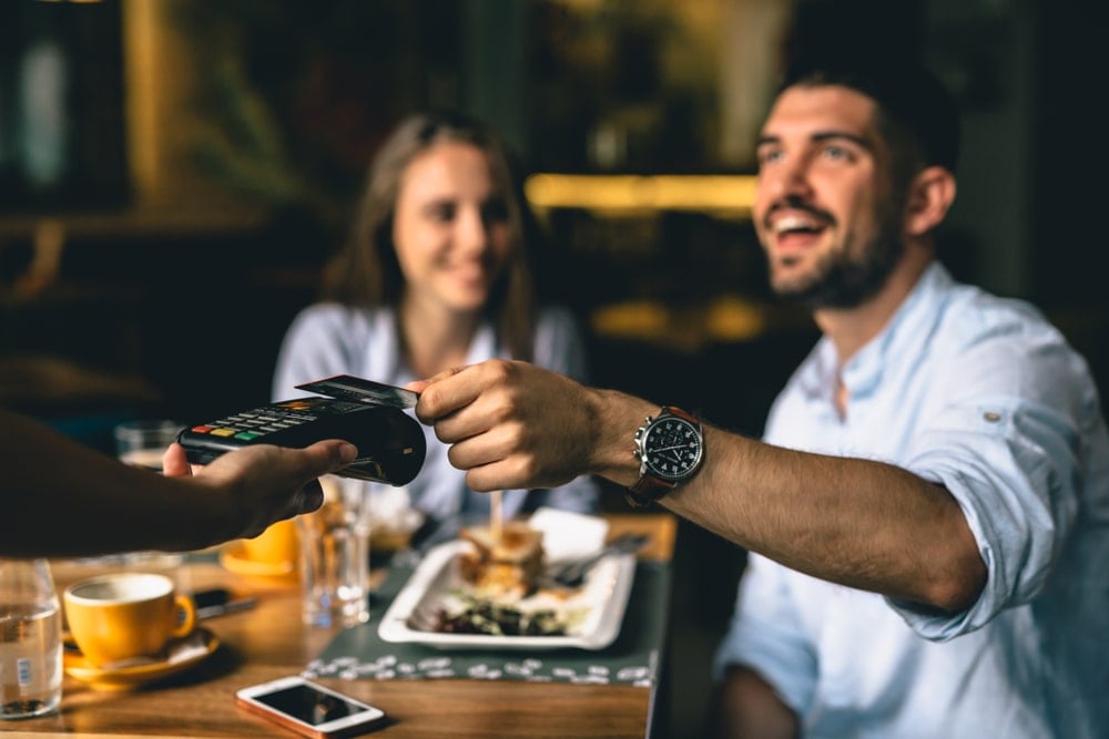 A restaurant guest paying for his meal.