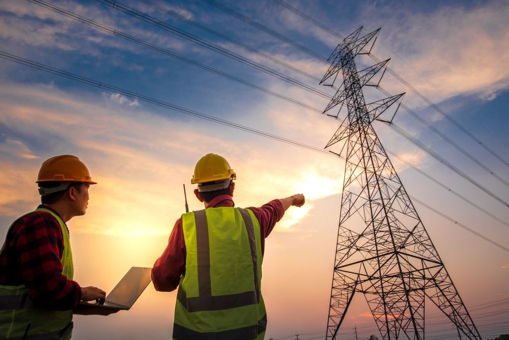 Electrical engineers analyzing the grid connection for DC charging infrastructure.