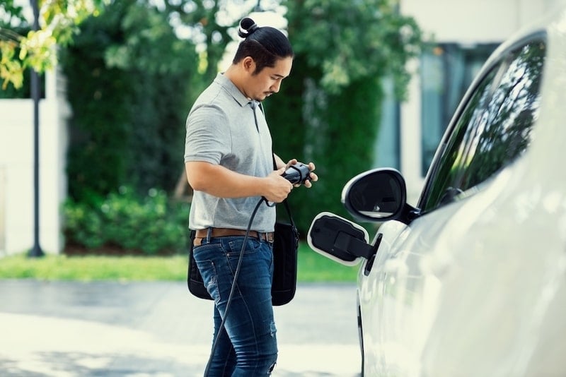 A man is charging his EV.