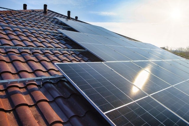 Solar panels on a roof absorbing sunshine.