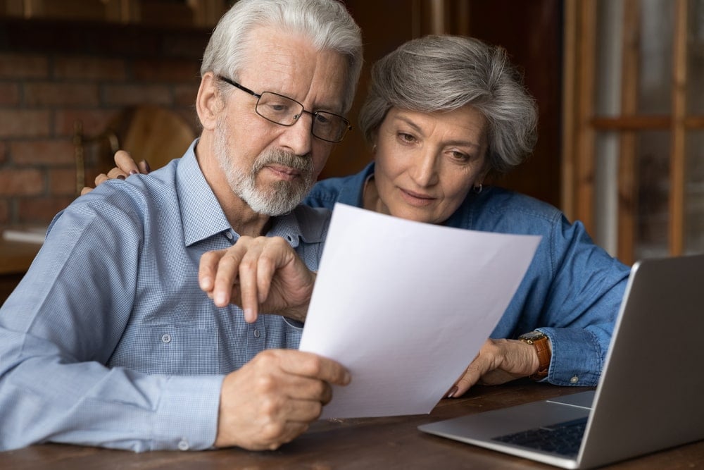 An old couple are checking information about how to install solar panels and different battery storage systems..