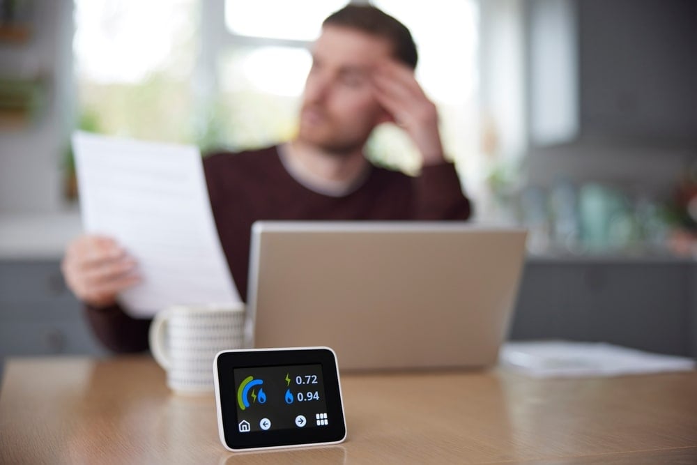 A man with a home energy management system is checking how much a battery storage system would cost