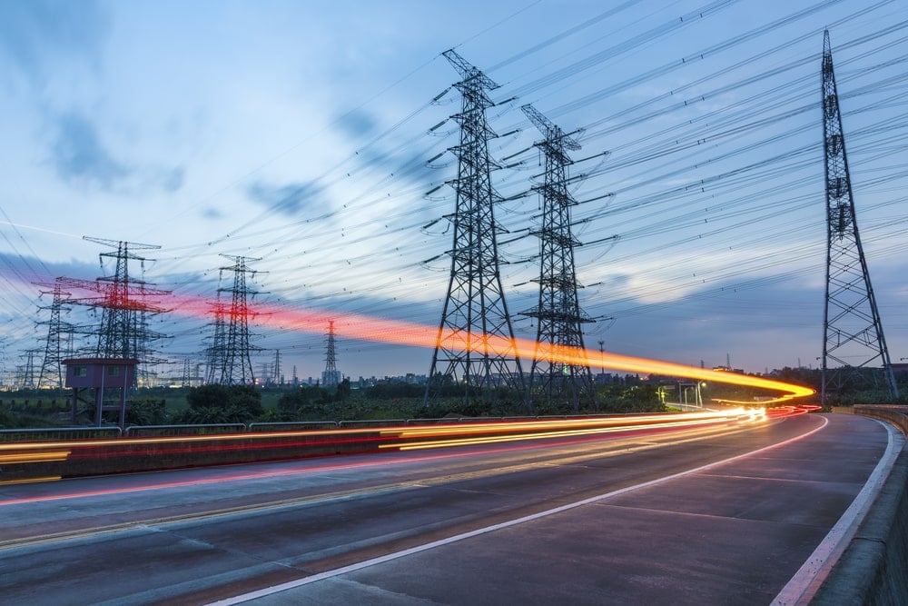 high speed road car track in the background of high voltage towers.