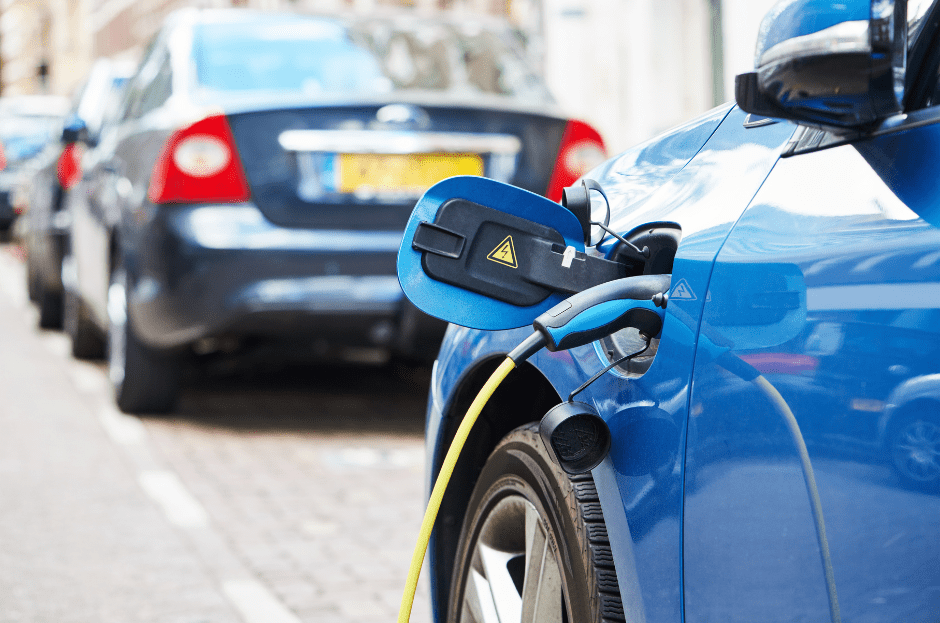 Blue electric car getting charged.