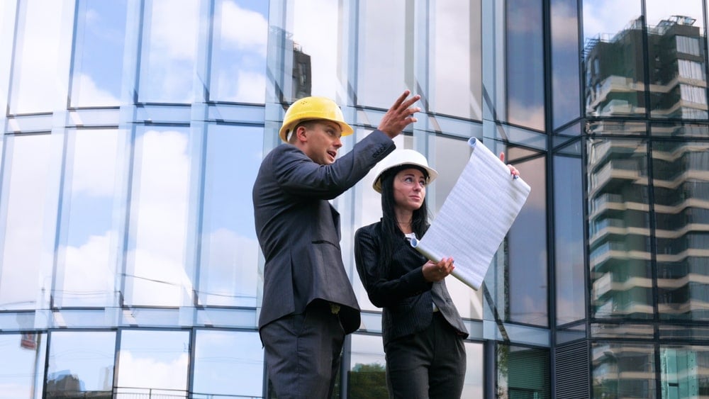 An engineer explaining the installation process on a workplace site to a manager.