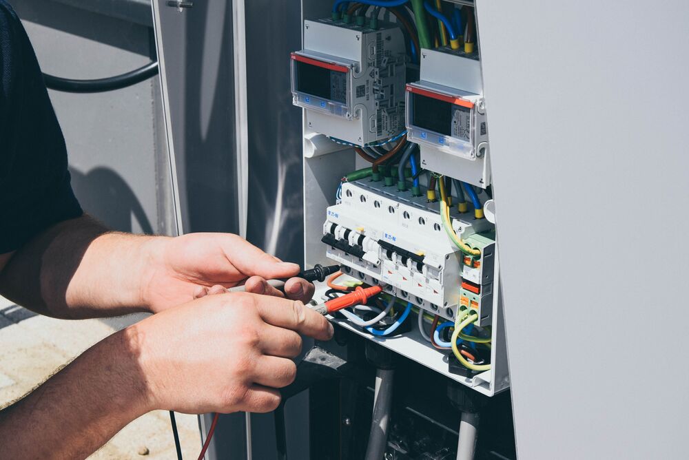 A close up view of an installer installing an EVBox EV charging station.