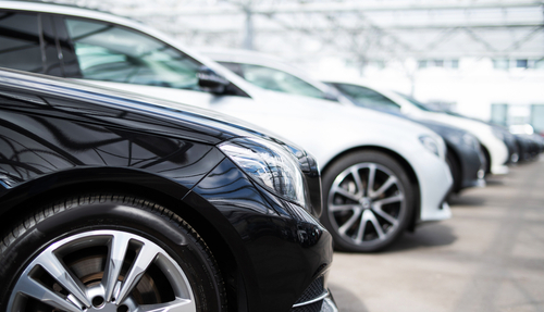 A number of new vehicles at a car dealership.