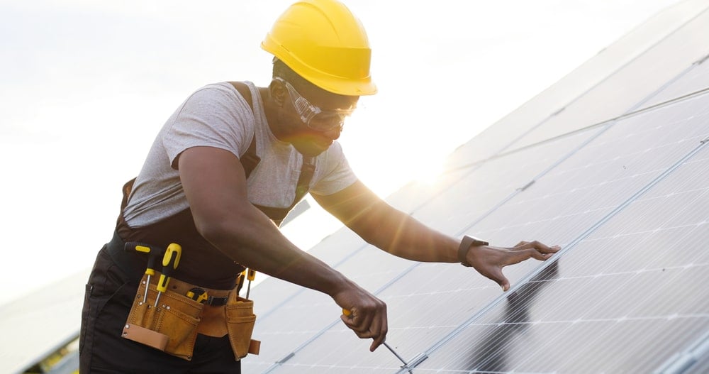 Expert installer installing solar panels on a rooftop.